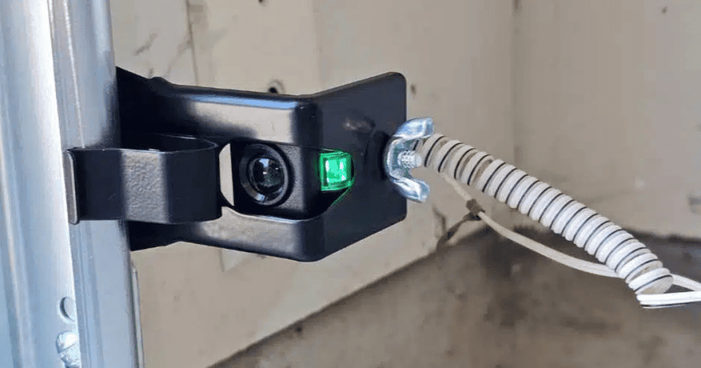 Garage door safety sensor with green light.
