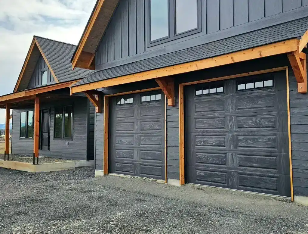 Stylish black garage doors with wood accents, perfect for security, gates, and fencing.