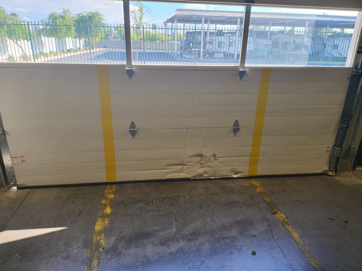 Damaged garage door panel before repair, Phoenix AZ