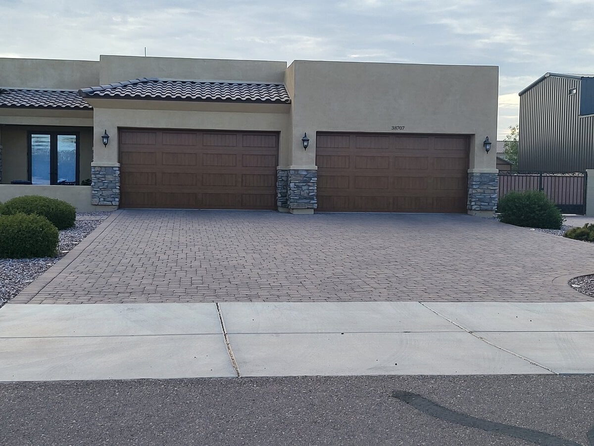 Three-car wood-look garage doors on paver driveway, Phoenix AZ