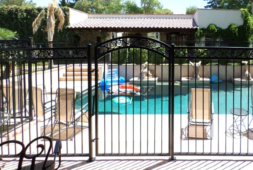 Arched iron pool gate installed in Scottsdale AZ