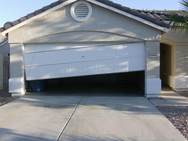 Crashed garage door off track before repair, Scottsdale AZ