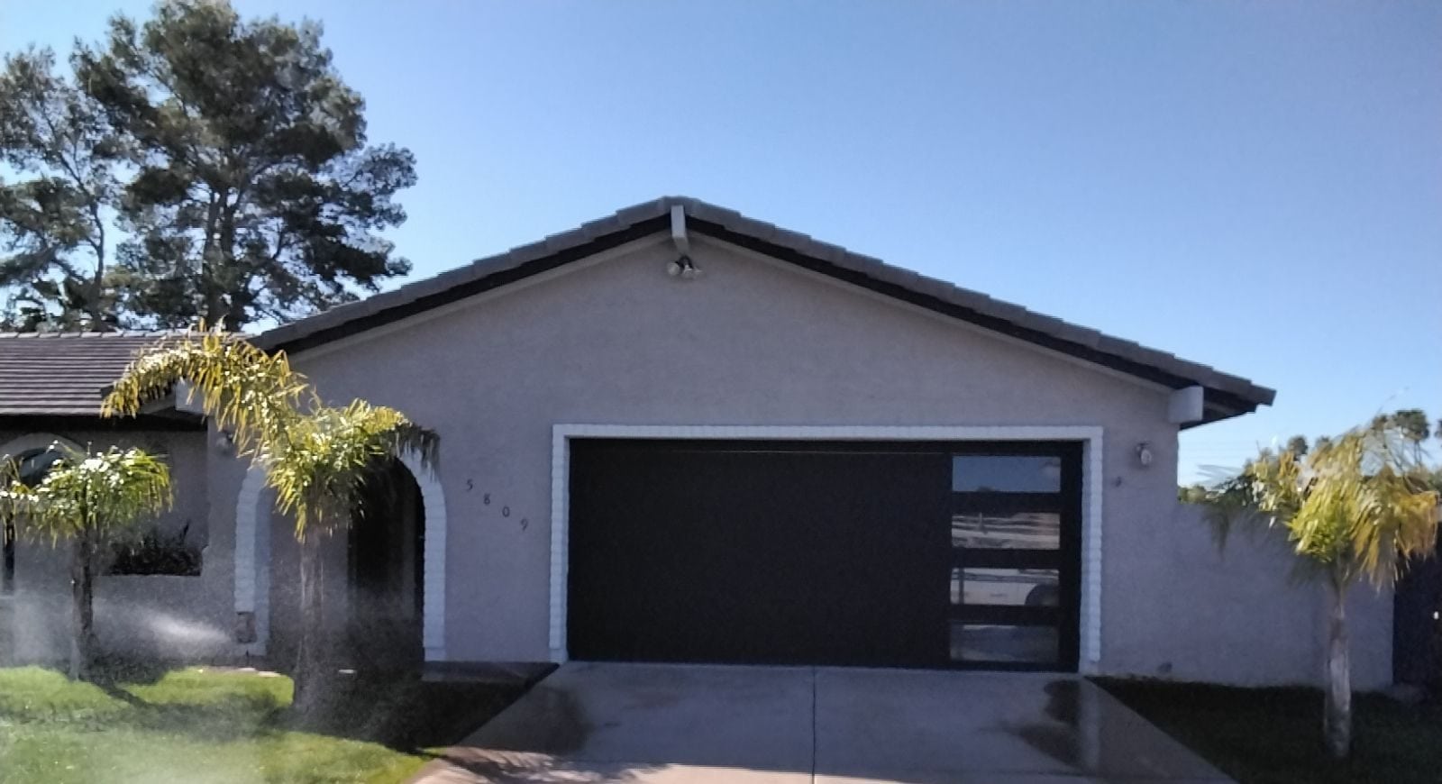 Modern flush panel garage door with windows installed in Scottsdale AZ