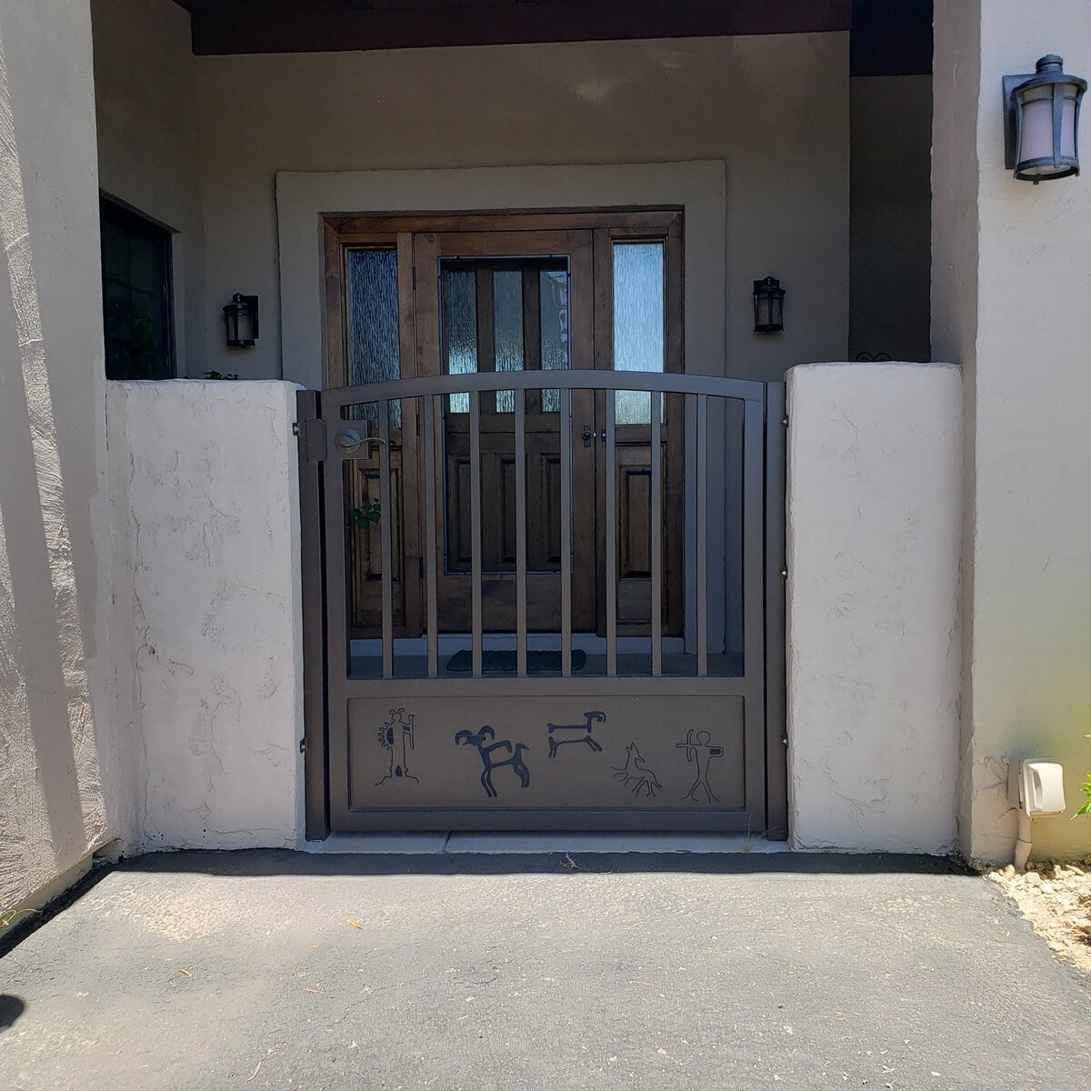 Custom iron entry gate with Southwest petroglyph design panel, Scottsdale AZ