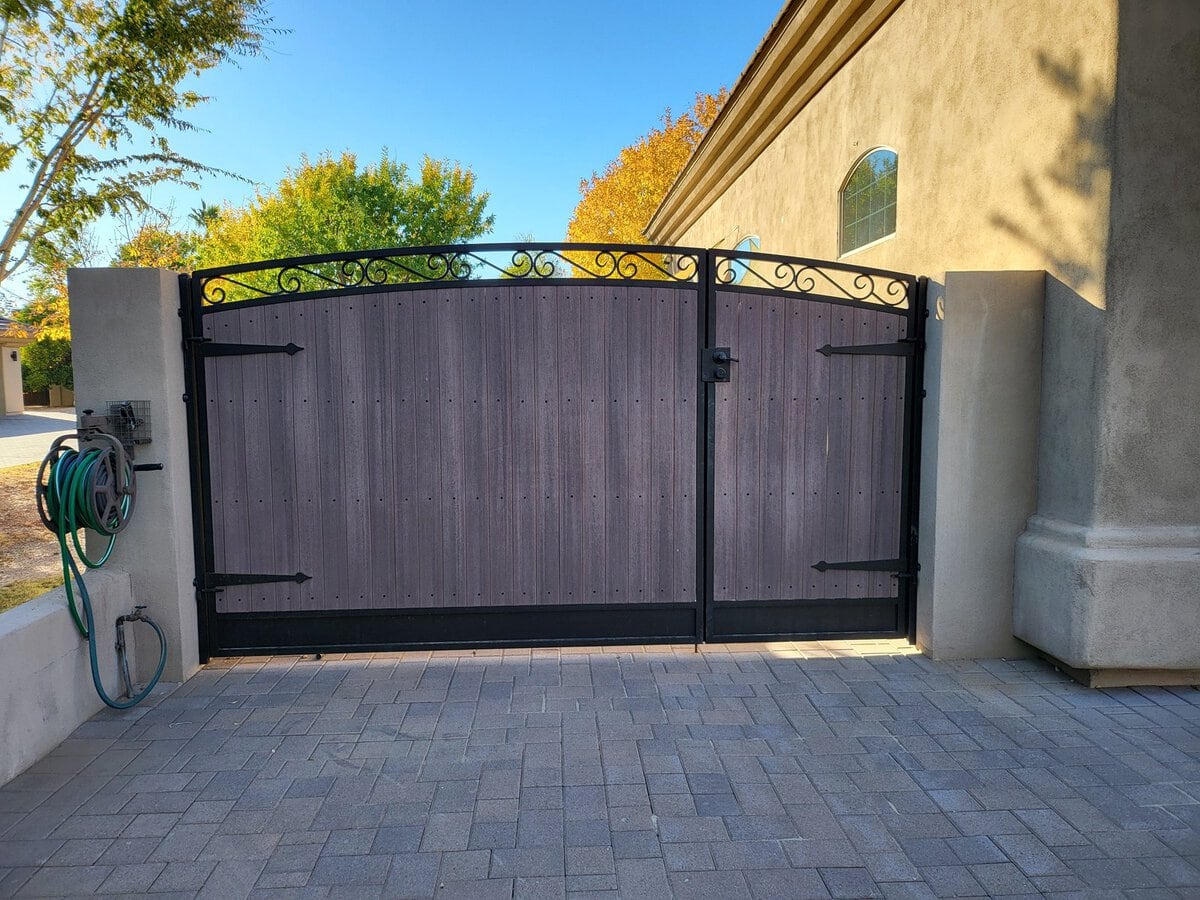 Wood-look driveway gate with wrought iron scroll top, Scottsdale AZ