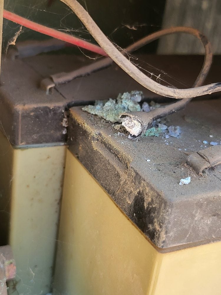 Corroded battery terminal and wiring inside automatic gate operator in Scottsdale AZ — common result of rodent nesting and moisture
