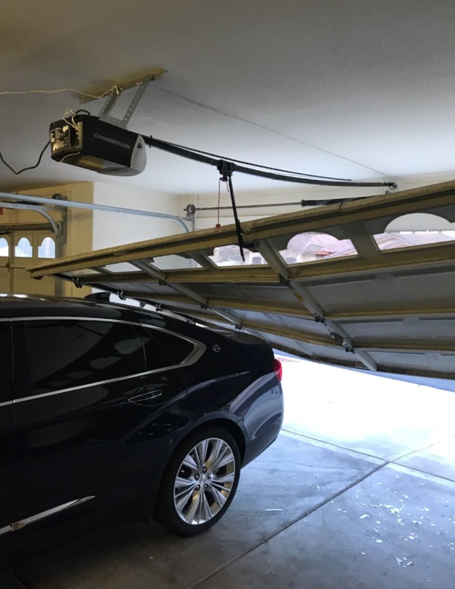 Car backed into garage door causing structural damage Scottsdale AZ