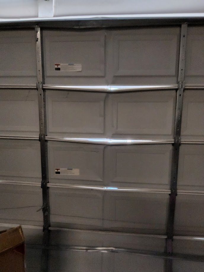 Damaged garage door panels needing replacement Scottsdale AZ
