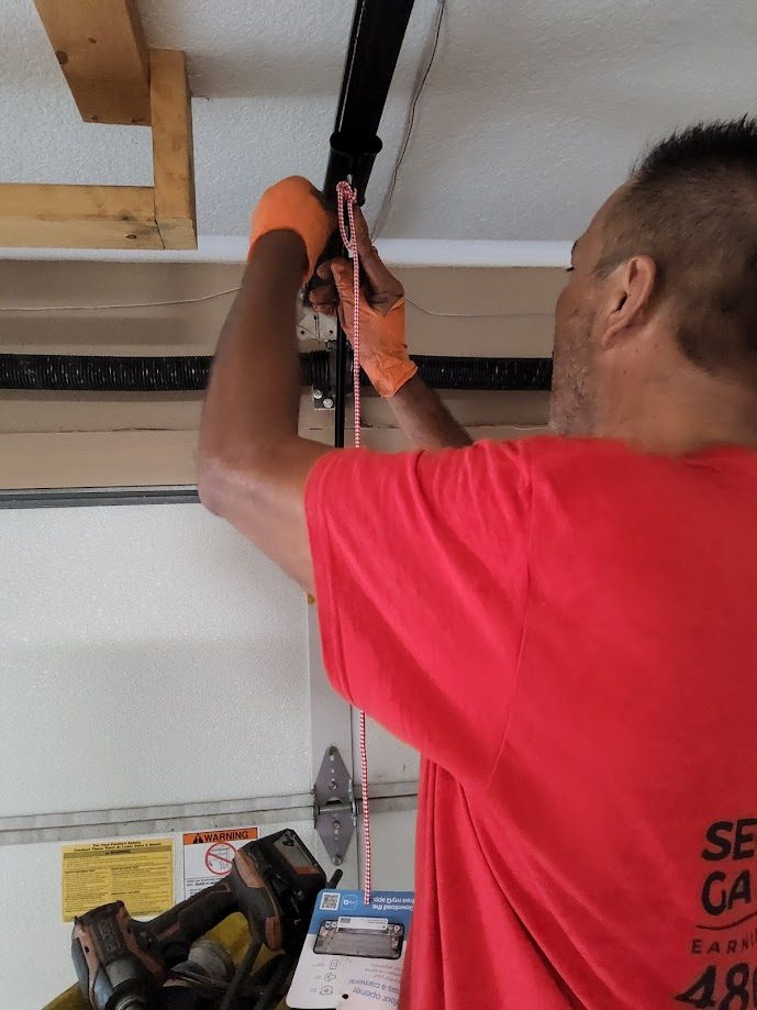 Technician replacing garage door torsion spring in Scottsdale AZ
