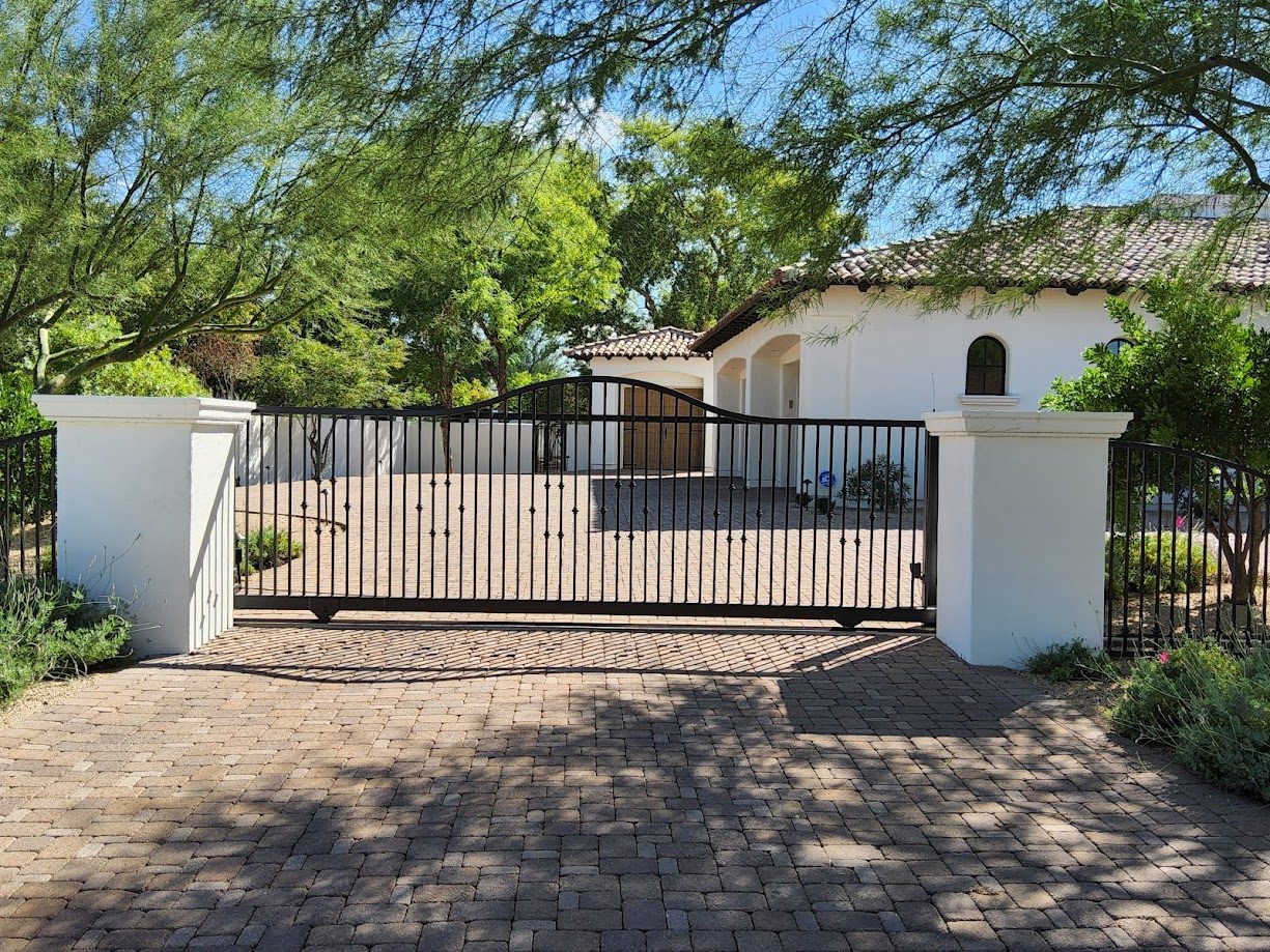 Custom iron scroll driveway gate at Scottsdale AZ estate