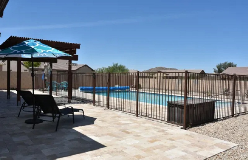 Wrought iron pool fence with natural patina finish in Scottsdale AZ