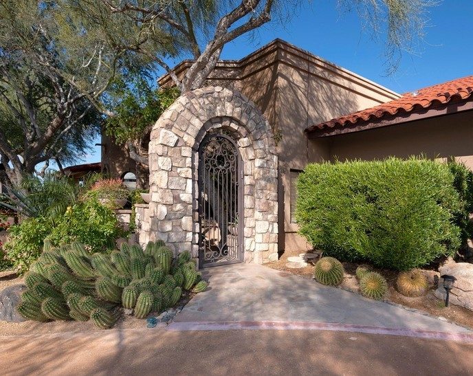 Stone archway iron entry gate installed in Scottsdale AZ
