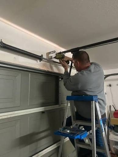 Technician repairing garage door spring Scottsdale AZ